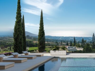 Render of pool deck with sun loungers and hillside views